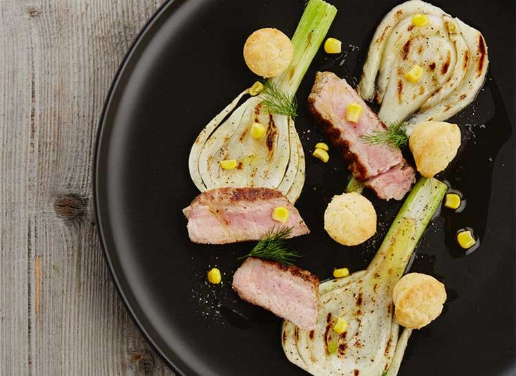 Baked veal oyster on grilled fennel with corn cake and liquorice drops