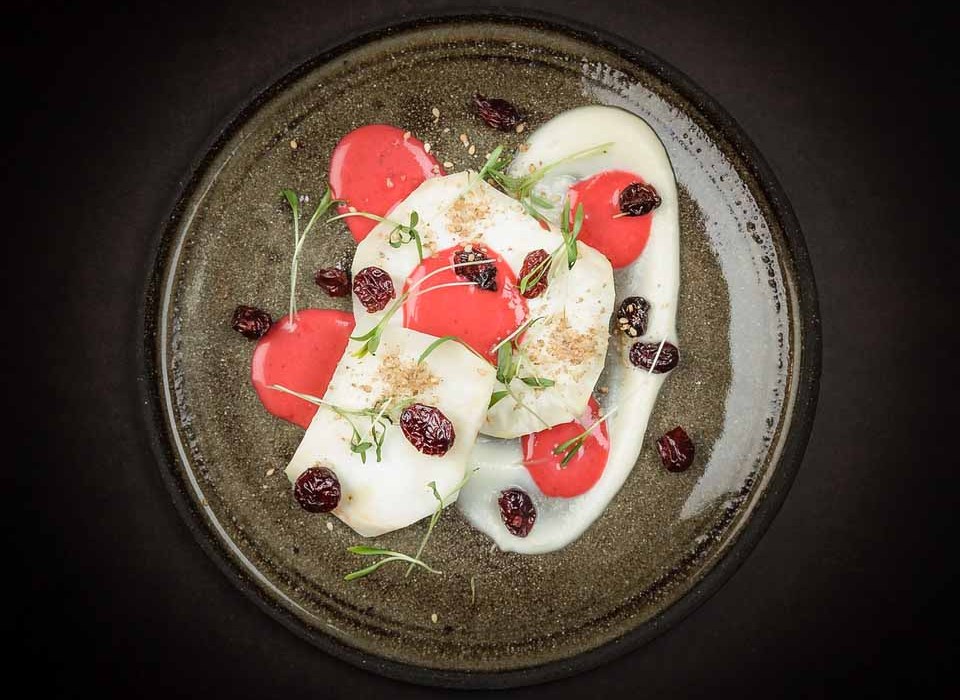 Celeriac on an open fire with gomasio and rosemary. Vinaigrette of pink grapefruit and cranberries. Dried cranberries and Ghoa cress.