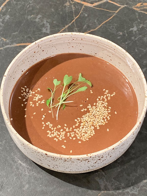 Potato chocolate soup with sesame and lemon balm