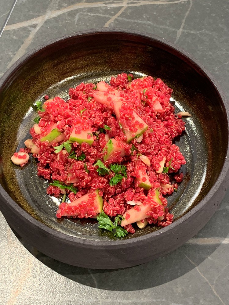 Quinoa salad with lemon juice, beetroot juice, apple, almond