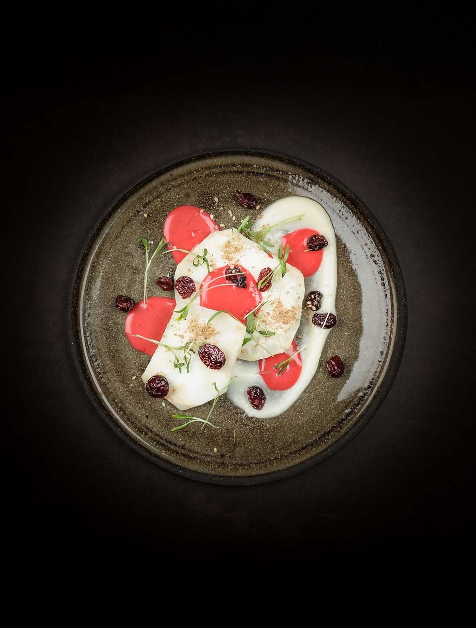 Celeriac on an open fire with gomasio and rosemary. Vinaigrette of pink grapefruit and cranberries. Dried cranberries and Ghoa cress.