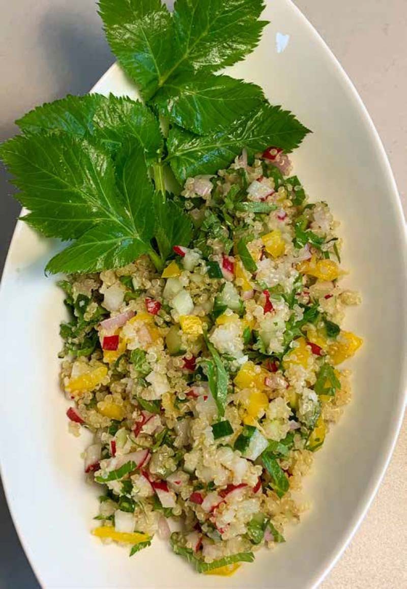 Quinoa salad with fresh vegetables and aromatic herbs