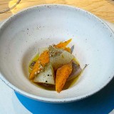 Burned shallot, carrot, turnip,  apple cider vinegar and pickled leek flowers. Kadeau – Copenhagen, Denmark