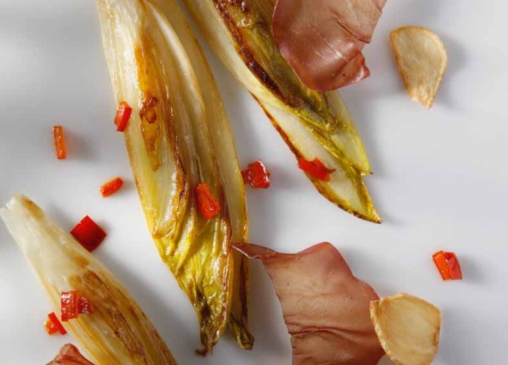 Plancha of Belgian Endive with Bresaola, Garlic Chips, and Bell Pepper Strips