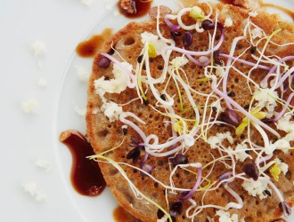 Pancakes made from oats and buckwheat with sprout mix and pear syrup.