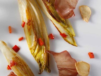 Plancha of Belgian Endive with Bresaola, Garlic Chips, and Bell Pepper Strips